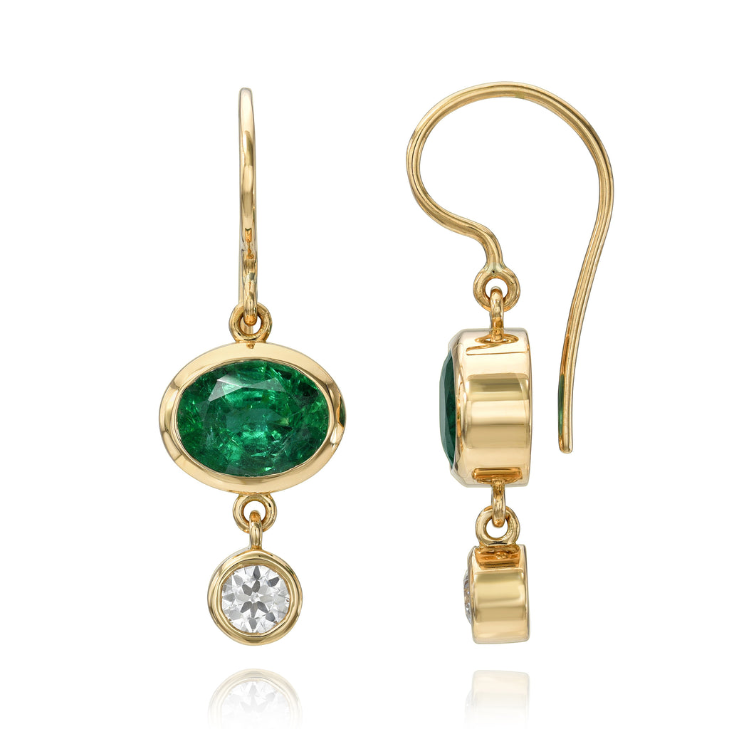 
Single Stone's Paloma double drops earrings  featuring 3.03ctw GIA certified Zambian oval cut green emeralds with 0.51ctw old European cut accent diamonds bezel set in handcrafted 18K yellow gold double drop earrings.
