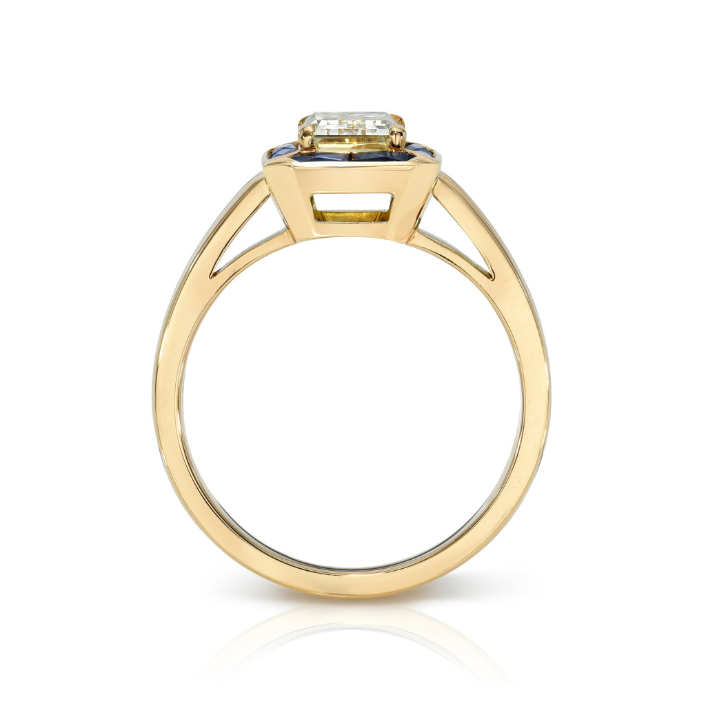 Single Stone's PIPPA ring  featuring 1.32ct S-T/SI1 GIA certified emerald cut diamond prong set with 1.18ctw French cut blue sapphire accent stones set in a handcrafted 18K yellow gold mounting.
