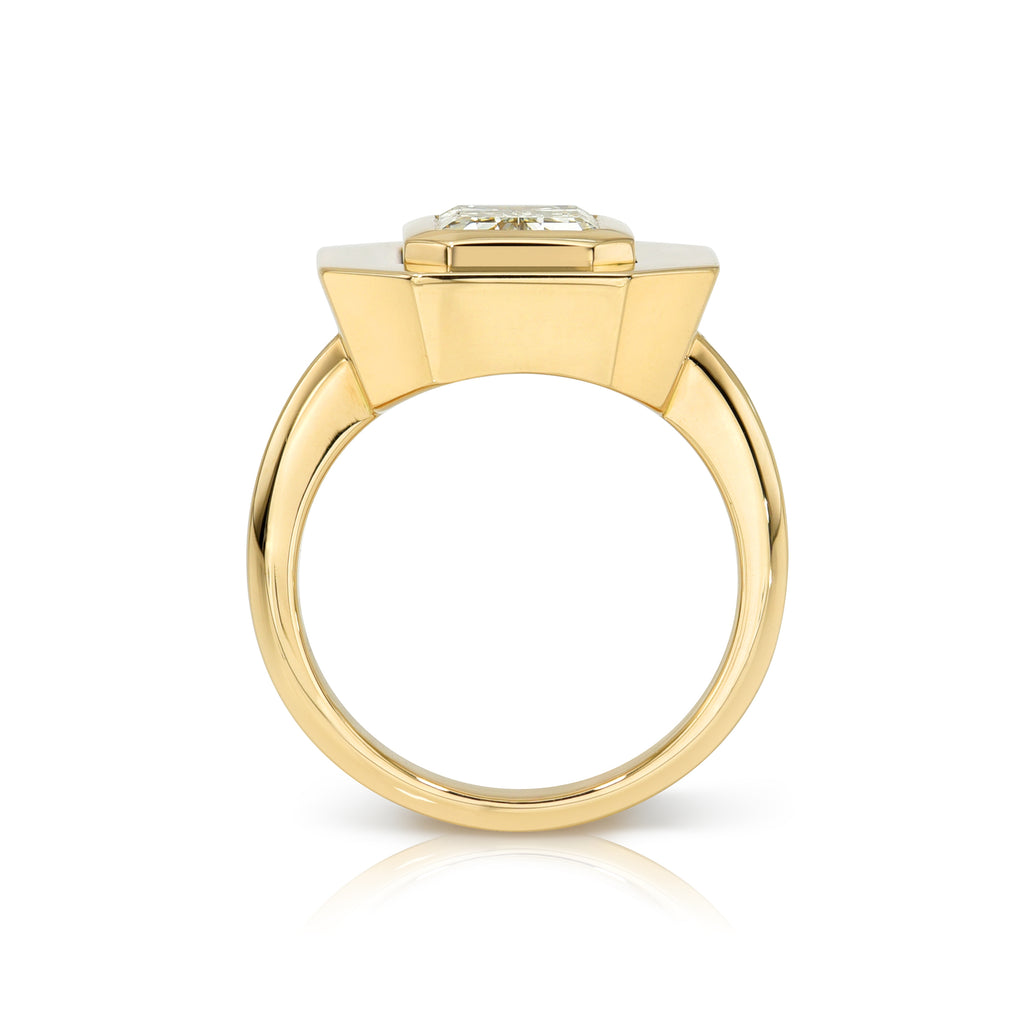 Single Stone's RENA ring  featuring 2.39ct W-X/VVS2 GIA certified emerald cut diamond bezel set in a handcrafted 18K yellow gold mounting.
