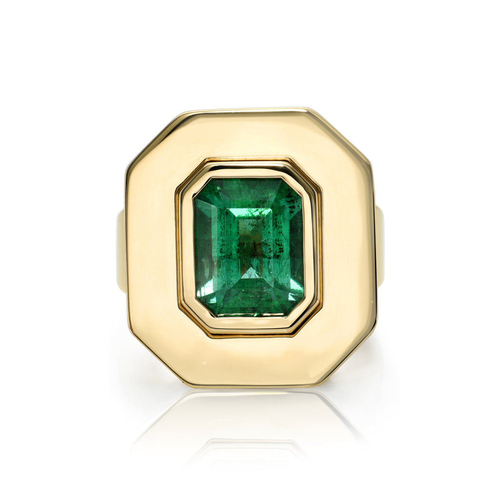 
Single Stone's Rena ring  featuring 3.14ct GIA certified emerald cut green emerald bezel set in a handcrafted 18K yellow gold mounting.
