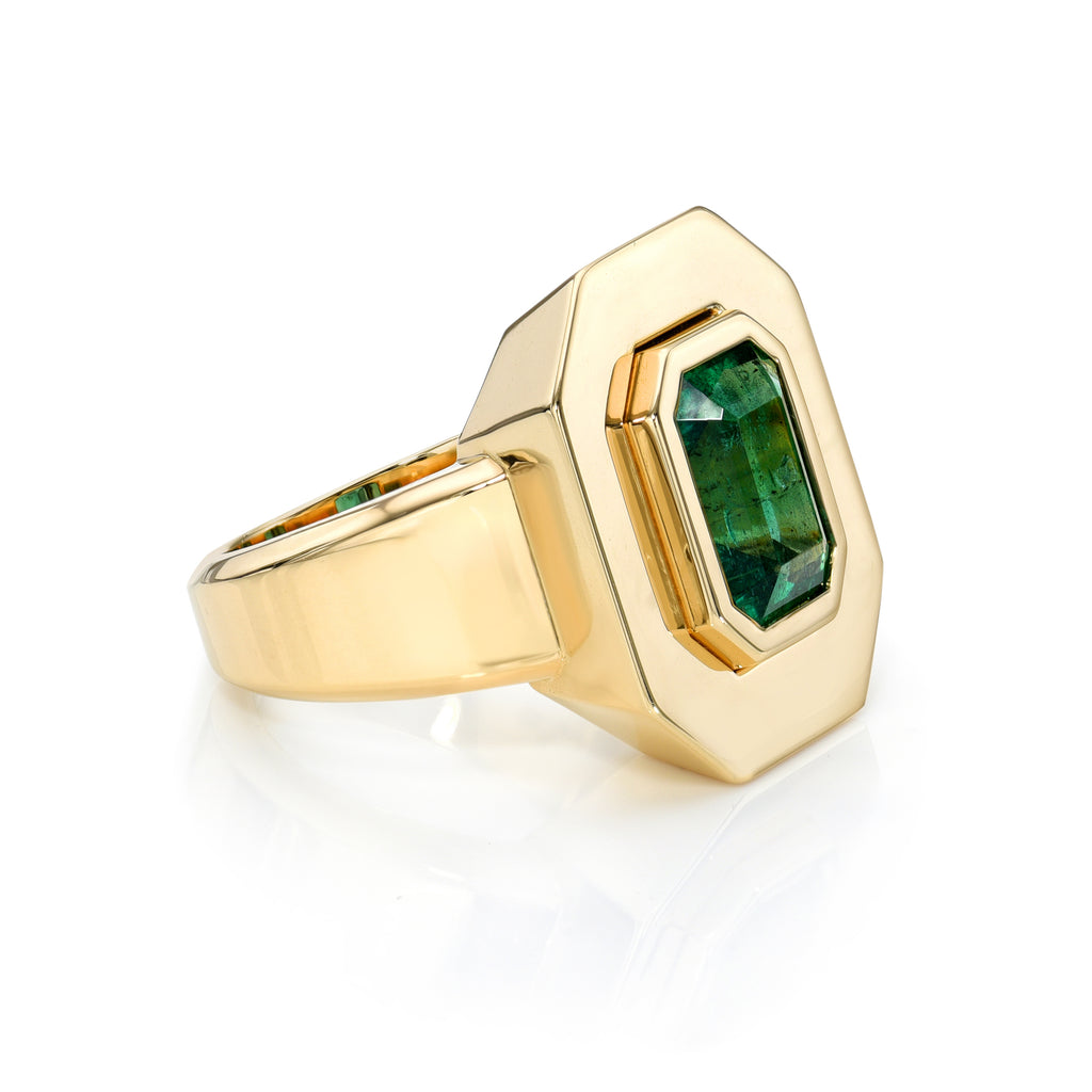 Single Stone's RENA ring  featuring 3.14ct GIA certified emerald cut green emerald bezel set in a handcrafted 18K yellow gold mounting.
