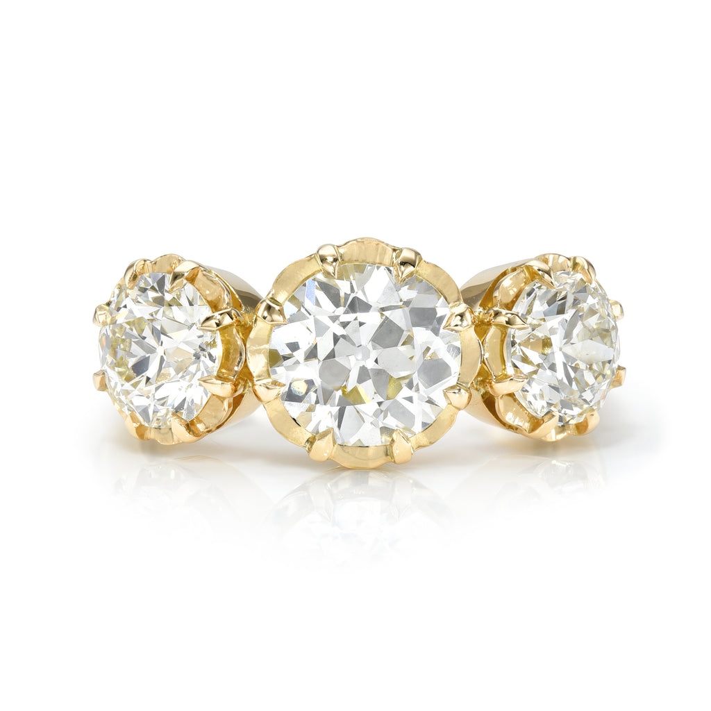 
Single Stone's Three stone jolene ring  featuring 3.31ctw J-K/VS1-VS2 GIA certified old European cut diamonds prong set in a handcrafted 18K yellow gold mounting.
