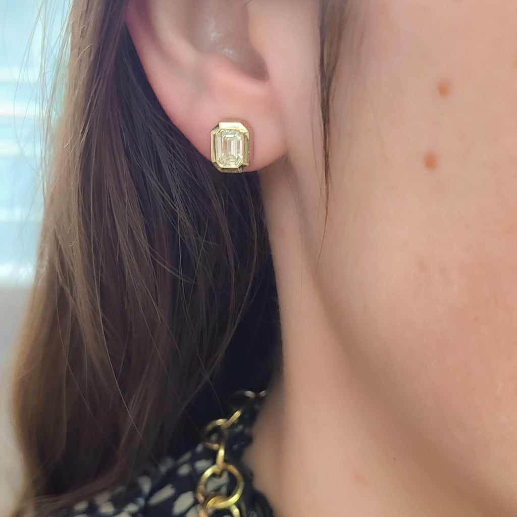 Single Stone's TEDDI STUDS earrings  featuring 1.91ctw M/VS2 GIA certified emerald cut diamonds bezel set in handcrafted 18K yellow gold stud earrings.
