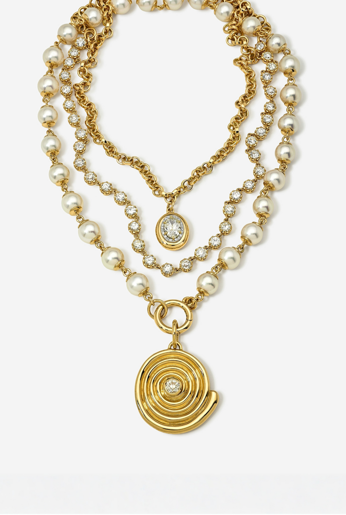A gold-toned multi-strand necklace featuring faux pearls, clear rhinestone accents, and a large spiral pendant with a central clear stone, displayed on a clean white background.