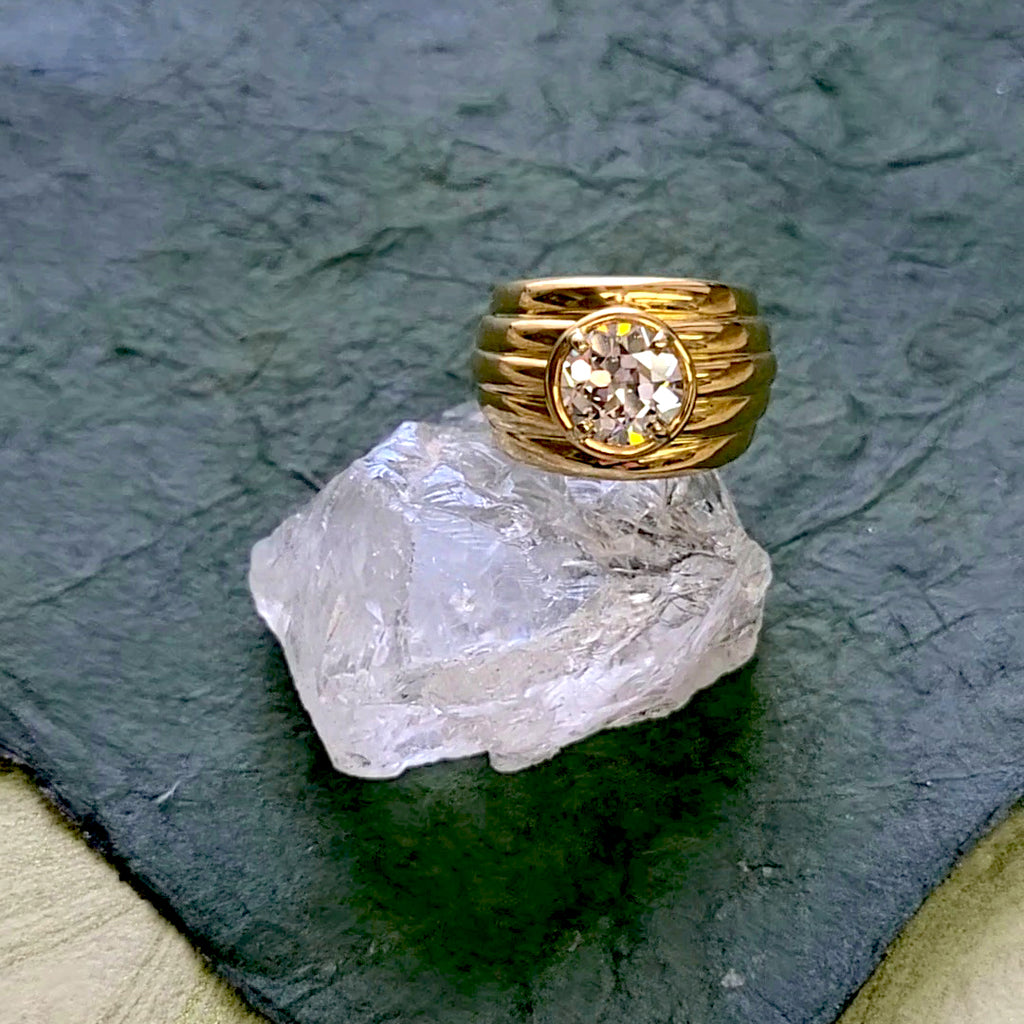 'Eleni' ring featuring an old European cut diamond in a wide yellow gold band