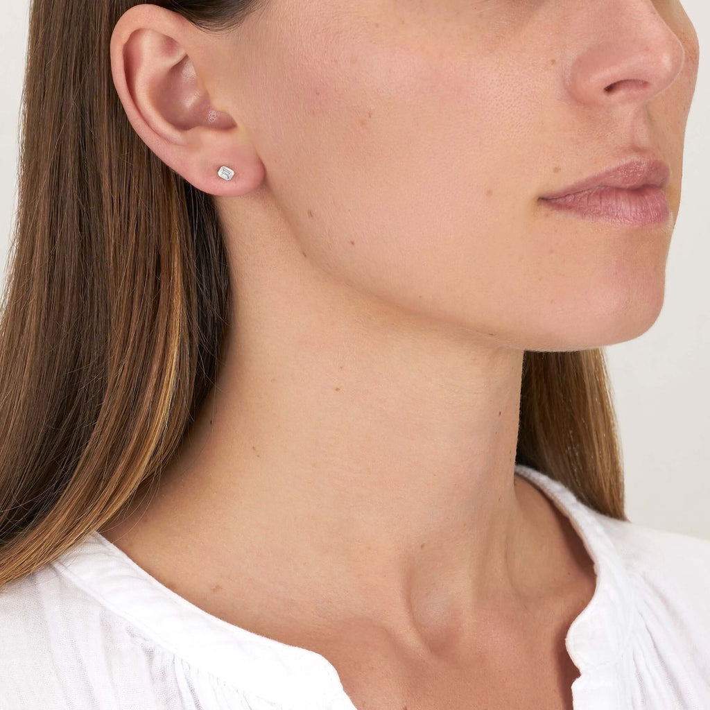 Single Stone's SIERRA STUDS earrings  featuring Approximately 0.18ctw G-I/VS emerald cut diamonds bezel set in handcrafted stud earrings. 
