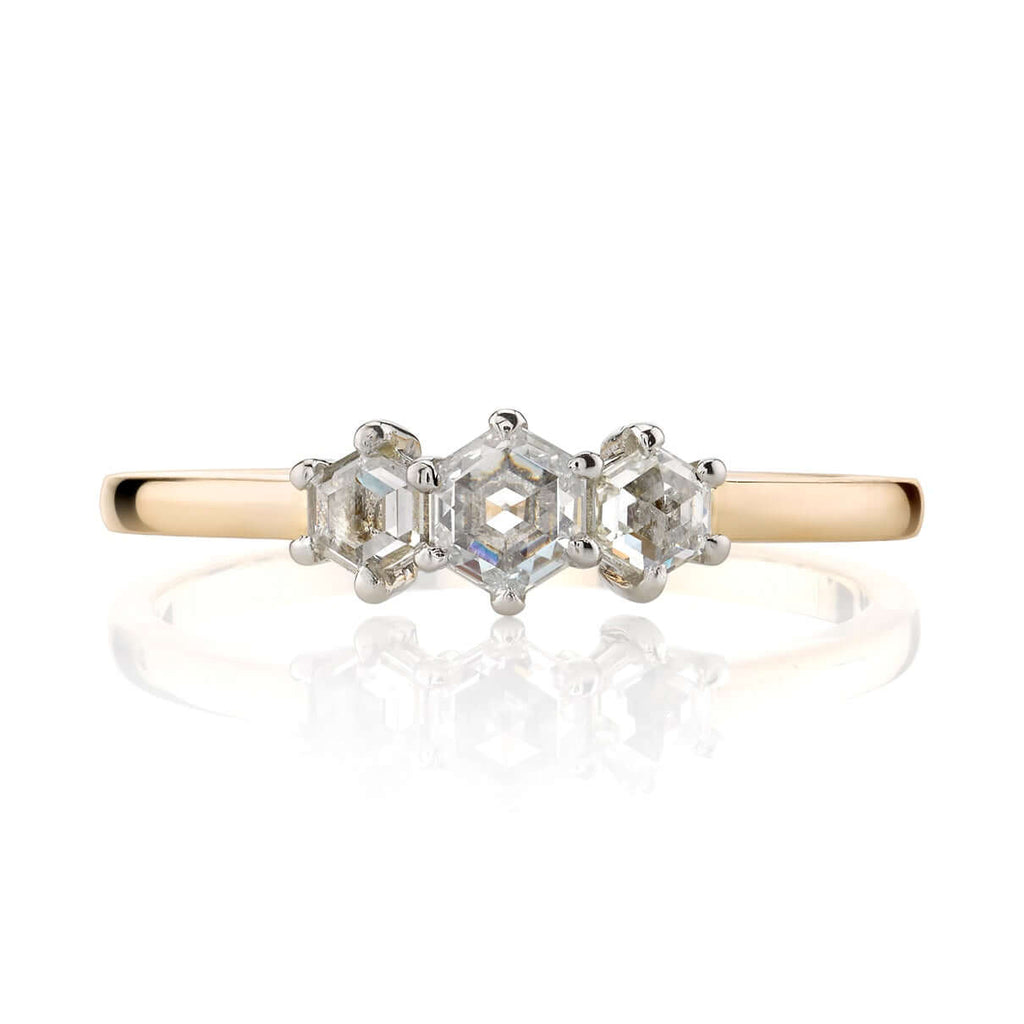 
Single Stone's Quincy ring  featuring 0.42ctw hexagonal rose cut diamonds prong set in a handcrafted 18K yellow gold and platinum three stone mounting.

