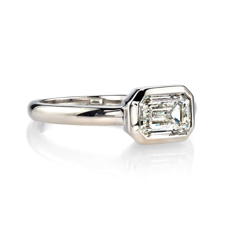 Single Stone's MARNI ring  featuring 1.20ct L/VVS1 GIA certified emerald cut diamond set in a handcrafted 18K champagne white gold mounting.
