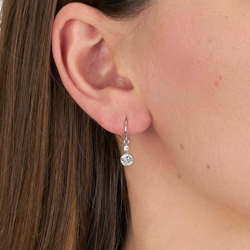 Single Stone's DUPRIE DROPS earrings  featuring 1.21ctw G-H/VS2-SI1 antique old mine cut diamonds with 0.10ctw French cut accent diamonds bezel set in handcrafted platinum double drop earrings.
