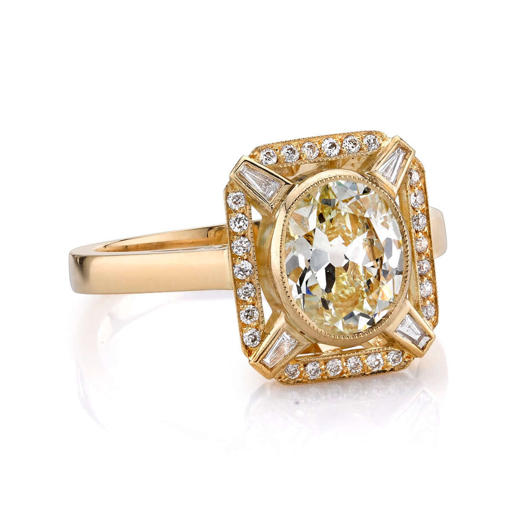 Single Stone's JENNIFER ring  featuring 1.31ct L/VS1 EGL certified antique oval cut diamond with 0.10ctw old European cut accent diamonds and 0.06ctw tapered baguette cut accent diamonds set in a handcrafted 18K yellow gold mounting.
