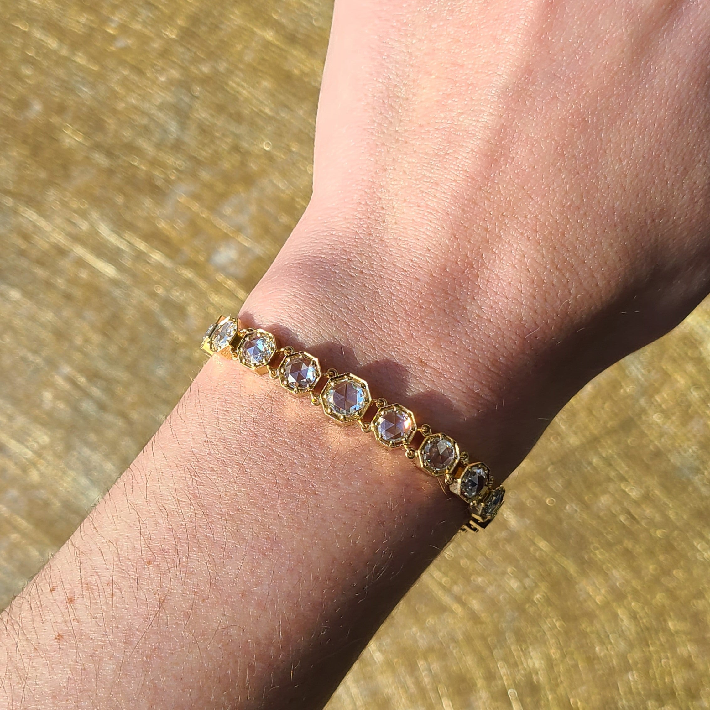SINGLE STONE COLBY BRACELET featuring 1.10ct I/SI2 GIA certified round rose cut diamond accompanied by 7.94ctw round rose cut diamonds prong set in a handcrafted 18K yellow gold bracelet. Bracelet measures 7.5".