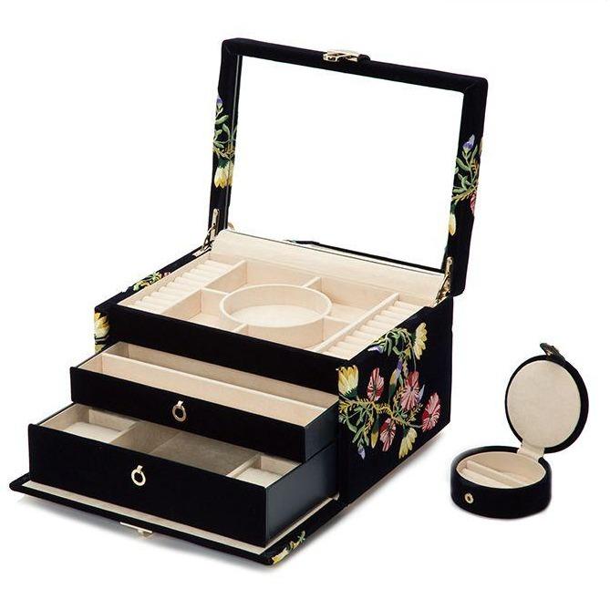 Single Stone's MEDIUM ZOE JEWELRY CASE  featuring Velvet jewelry case embroidered with classic floral designs. Jewelry case includes a total of 10 compartments. 4 medium compartments, 3 large compartments, 4 bracelet compartments, 4 bracelet/watch cuffs, and removable mini travel piece. LusterLoc™: Allows the fabric lining the inside of your jewelry cases to absorb th

