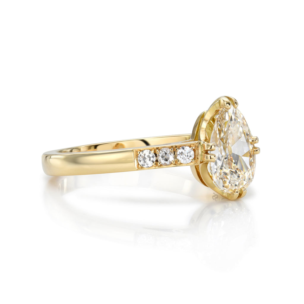 Single Stone's BAUER ring  featuring 1.01ct L/VS2 GIA certified pear shaped diamond with 0.06ctw old European cut accent diamonds set in a handcrafted 18K yellow gold mounting.  
