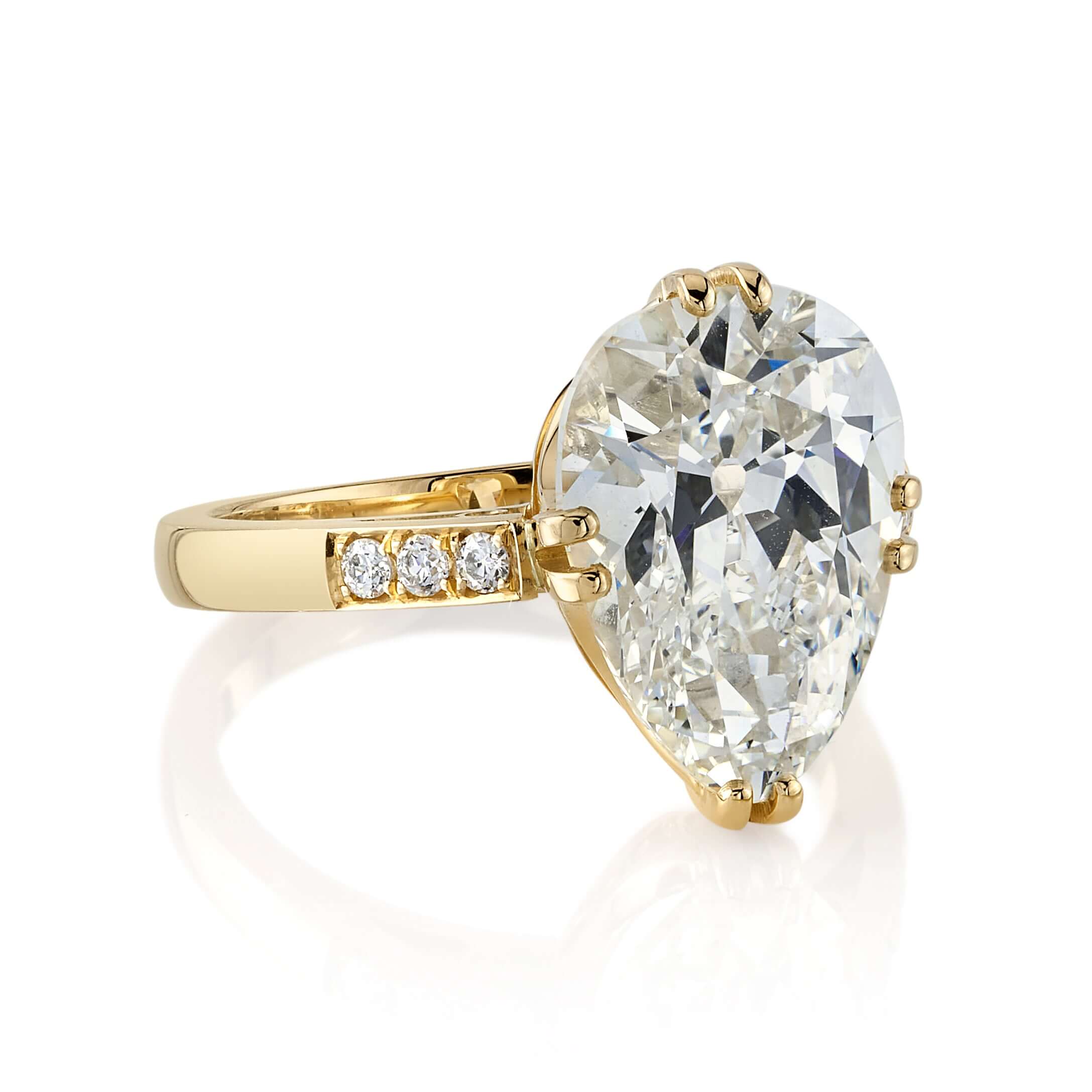 SINGLE STONE BAUER RING featuring 5.00ct L/VVS1 GIA certified antique pear shaped diamond with 0.11ctw old European cut accent diamonds set in a handcrafted 18K yellow gold mounting.