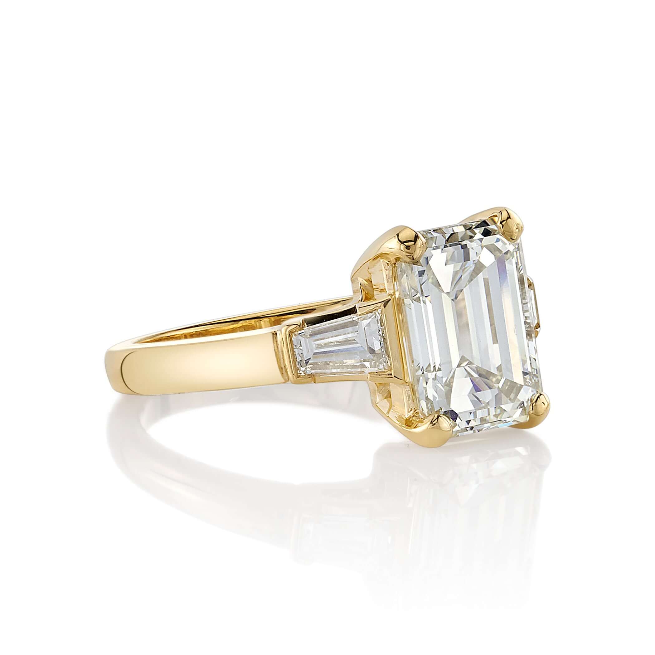 SINGLE STONE FAY RING featuring 3.30ct S-T/VVS2 GIA certified emerald cut diamond with 0.55ctw baguette cut accent diamonds prong set in a handcrafted 18K yellow gold setting.