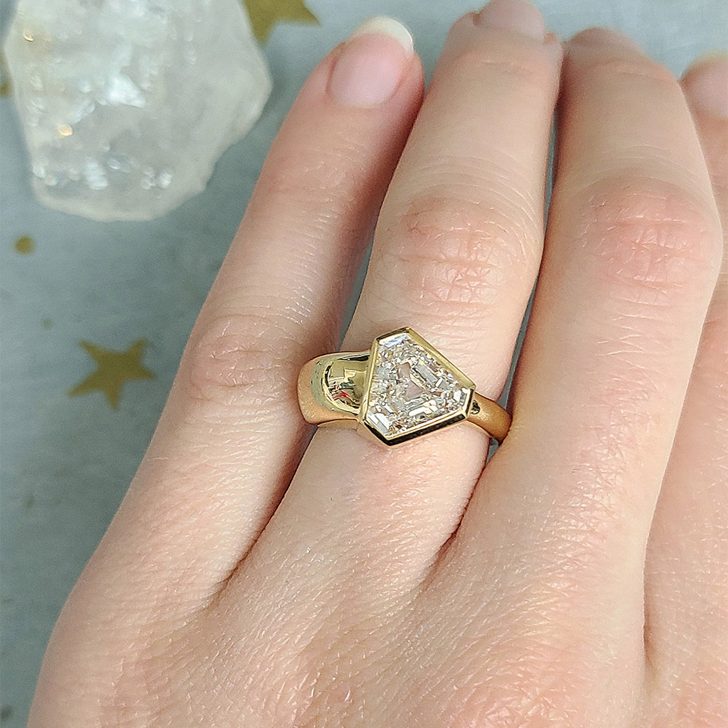 Single Stone's EZRA ring  featuring 2.50ct F/SI1 GIA certified vintage Trapezoid cut diamond bezel set in a handcrafted 18K yellow gold mounting with a tapered shank.
