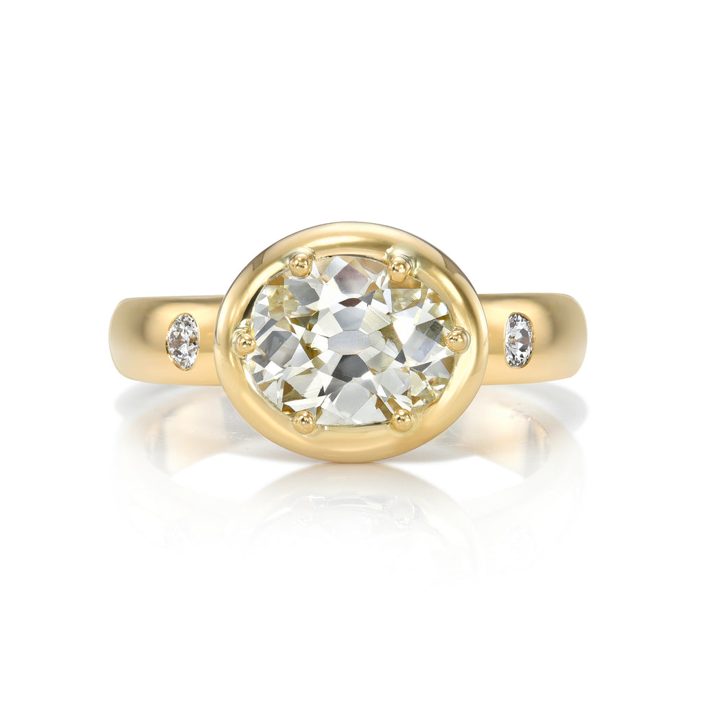 Single Stone's FRIDA ring  featuring 1.55ct L/VS2 GIA certified oval cut diamond with 0.07ctw old European cut accent diamonds prong set in a handcrafted 18K yellow gold mounting.
