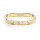 SINGLE STONE KARINA BANGLE featuring Approximately 1.35ctw H-I/VS French cut diamonds bezel set in a handcrafted 18K yellow gold bangle bracelet.