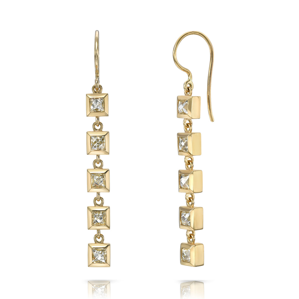 
Single Stone's Karina duster  featuring 3.35ctw I-J/VS French cut diamonds bezel set in handcrafted 18K yellow gold drop earrings.
