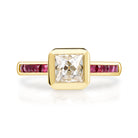 SINGLE STONE KARINA RING featuring 1.16ct G/VS2 GIA certified French cut diamond with 0.42ctw French cut ruby accent stones bezel set in a handcrafted 18K yellow gold mounting.