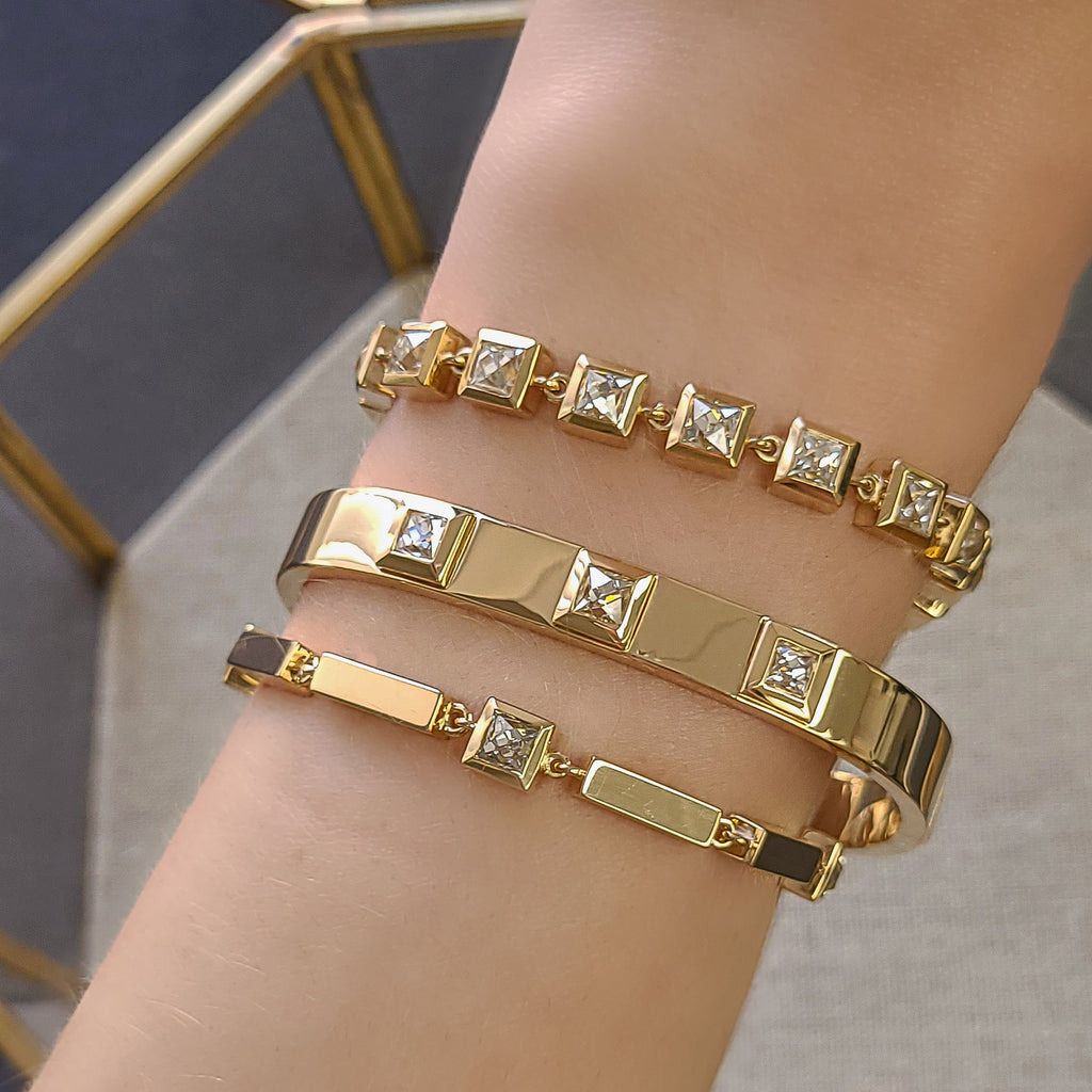 Single Stone's LARGE KARINA BRACELET  featuring 8.65ctw H-I/SI-VS French cut diamonds bezel set in a handcrafted 18K yellow gold bracelet. Bracelet measures 7.5&quot;
