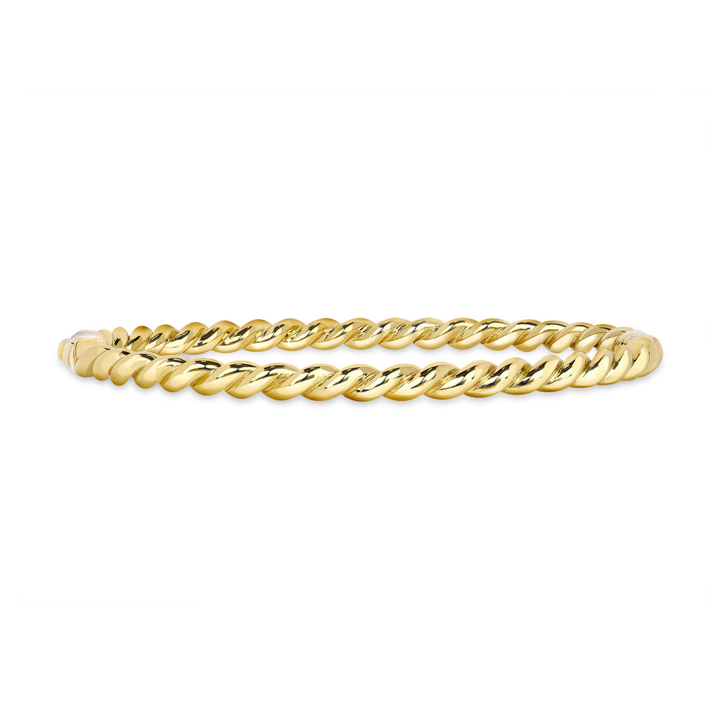 
Single Stone's Lara bangle  featuring Handcrafted twisted 18K yellow gold bangle bracelet.
 
