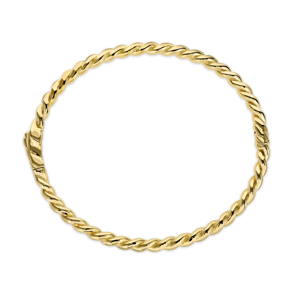 Single Stone's LARA BANGLE  featuring Handcrafted twisted 18K yellow gold bangle bracelet.  
