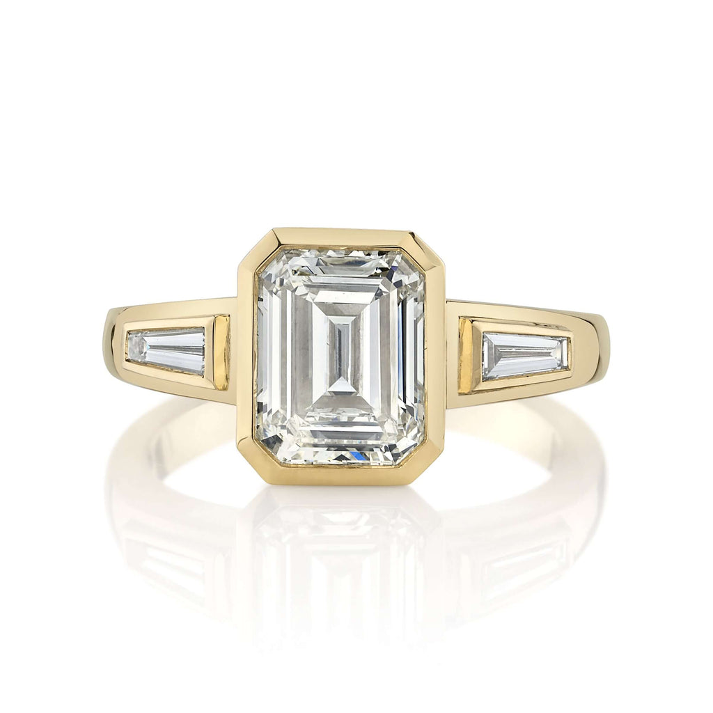 
Single Stone's Laurie ring  featuring 2.00ct N/VS2 GIA certified emerald cut diamond with 0.24ctw baguette cut accent diamonds bezel set in a handcrafted 18K yellow gold mounting.

