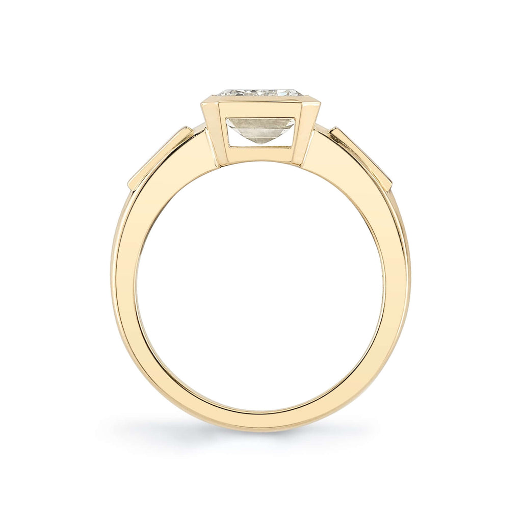 Single Stone's LAURIE ring  featuring 2.00ct N/VS2 GIA certified emerald cut diamond with 0.24ctw tapered baguette cut accent diamonds bezel set in a handcrafted 18K yellow gold mounting.
