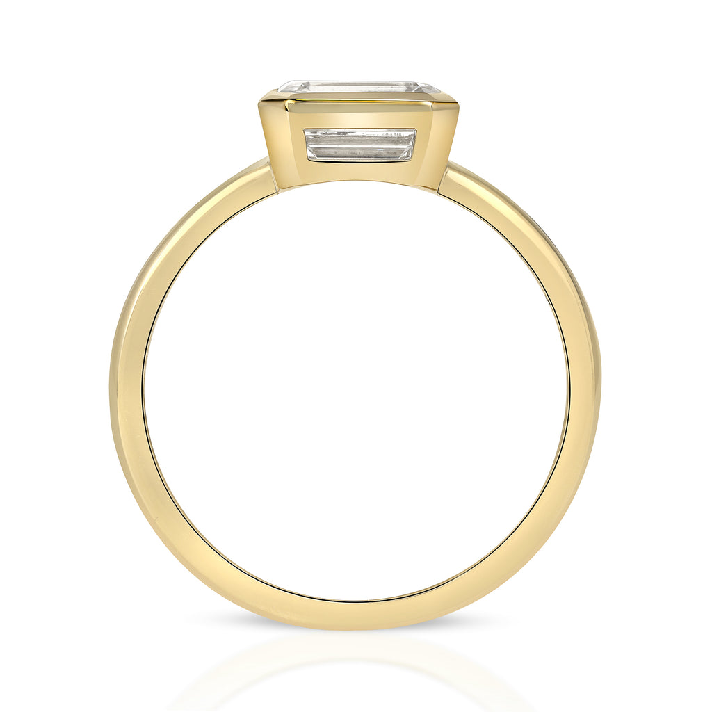 Single Stone's LEAH ring  featuring 1.04ct K/VS2 GIA certified emerald cut diamond bezel set in a handcrafted 18K yellow gold mounting,
