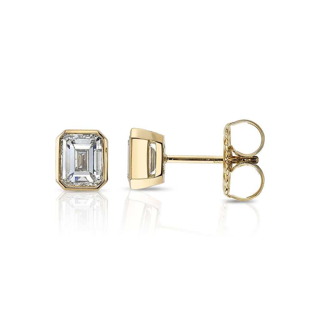 
Single Stone's Leah studs earrings  featuring 2.00ctw K-L/VVS2-SI1 GIA certified emerald cut diamonds bezel set in handcrafted 18K yellow gold stud earrings.

