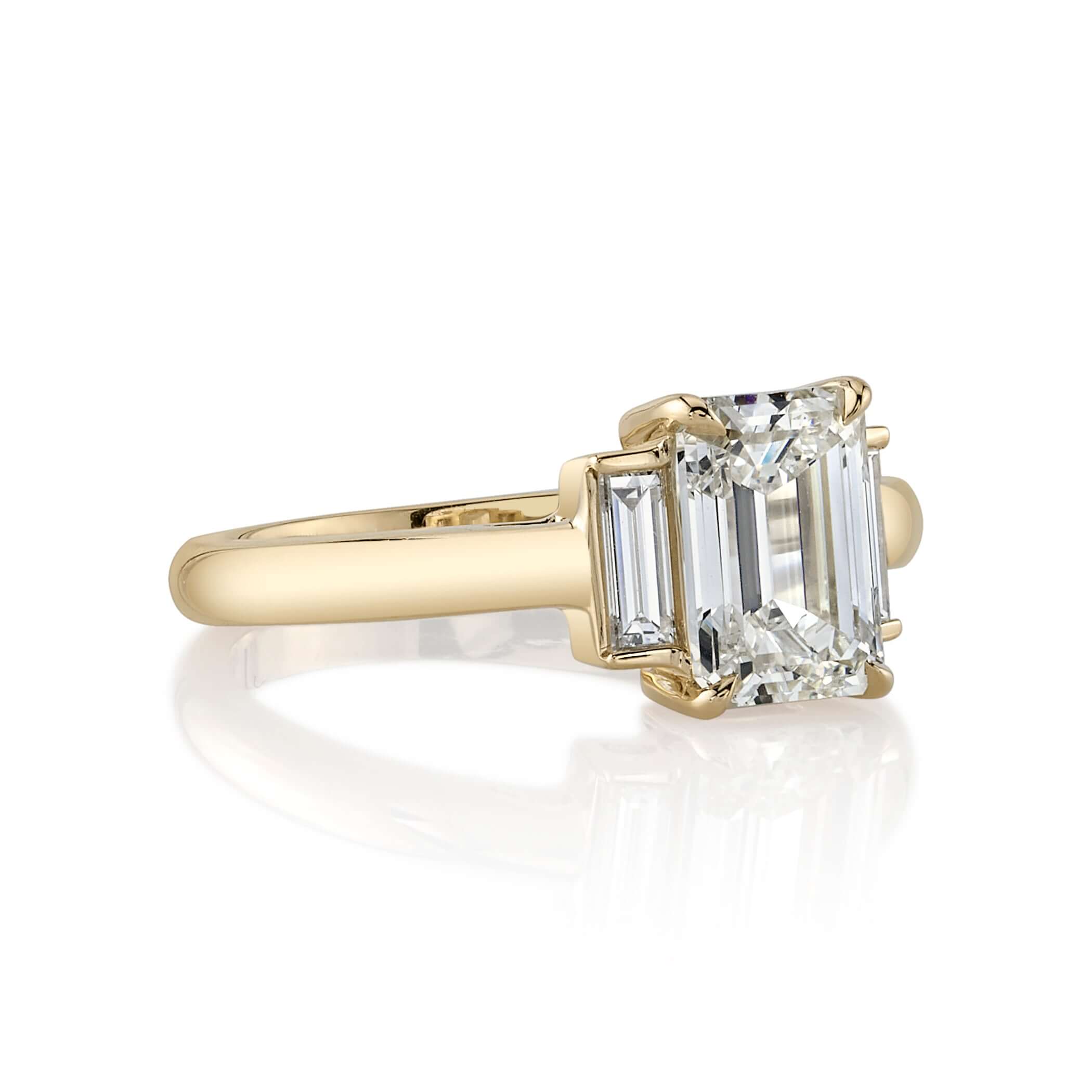 SINGLE STONE LONDON RING featuring 1.72ct M/VVS1 GIA certified emerald cut diamond with 0.25ctw baguette cut accent diamonds set in a handcrafted 18K yellow gold mounting.