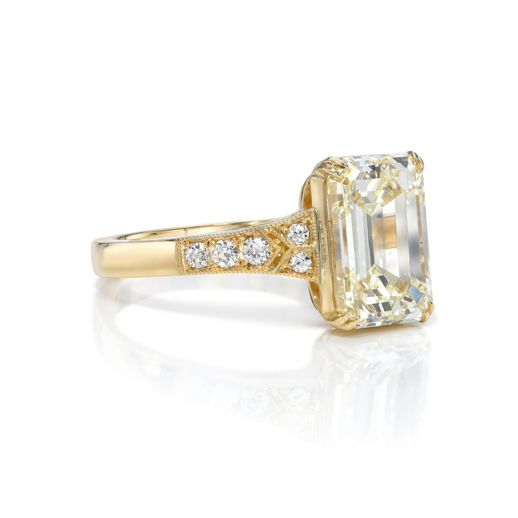 Single Stone's LORRAINE ring  featuring 3.01ct O-P/VS2 GIA certified emerald cut diamond with 0.07ctw old European cut accent diamonds set in a handcrafted 18K yellow gold mounting.
