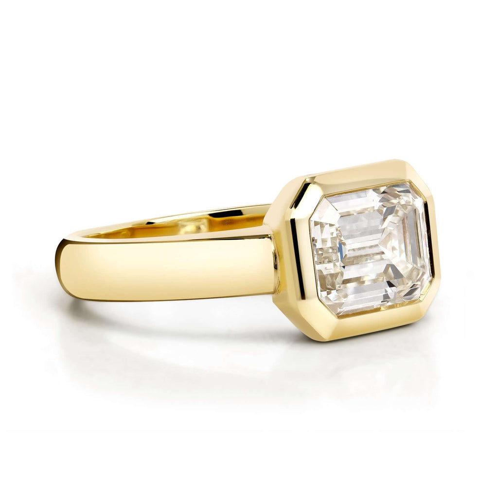 Single Stone's MARNI ring  featuring 2.14ct L/VS1 GIA certified emerald cut diamond bezel set in a handcrafted 18K yellow gold mounting.
