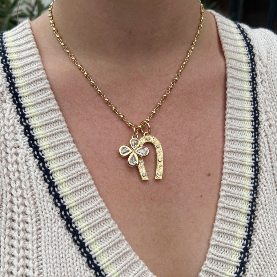 Single Stone's SMALL MARILYN pendant  featuring Approximately 0.25ctw G-H/VS old European cut diamonds bezel set in a handcrafted, hand-engraved 18K yellow gold horseshoe shaped pendant.
