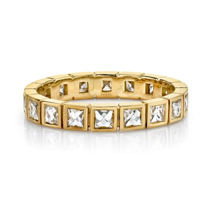 SINGLE STONE SMALL KARINA BAND | Approximately 1.00ctw G-H/VS French cut diamonds bezel set in a handcrafted eternity band. Approximate band width 2mm. Please inquire about additional customization.