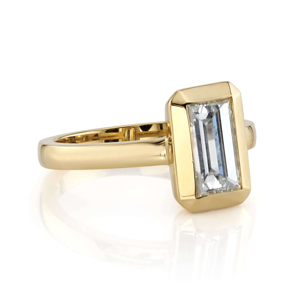 Single Stone's BEA ring  featuring 1.27ct I/VS2 GIA certified rectangular step cut diamond bezel set in a handcrafted 18K yellow gold mounting.

