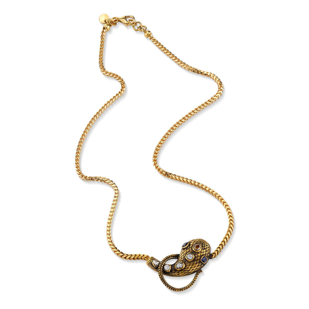 Single Stone's ALEXANDRIA SERPENT NECKLACE  featuring 0.86ctw antique old mine, antique cushion, and pear cut diamonds featuring 0.44ctw cushion cut blue sapphire accent stones set on a handcrafted, oxidized 18K yellow gold snake pendant. Includes18K yellow gold chain. Chain measures 18&quot;, also available as a wrap bracelet. 
