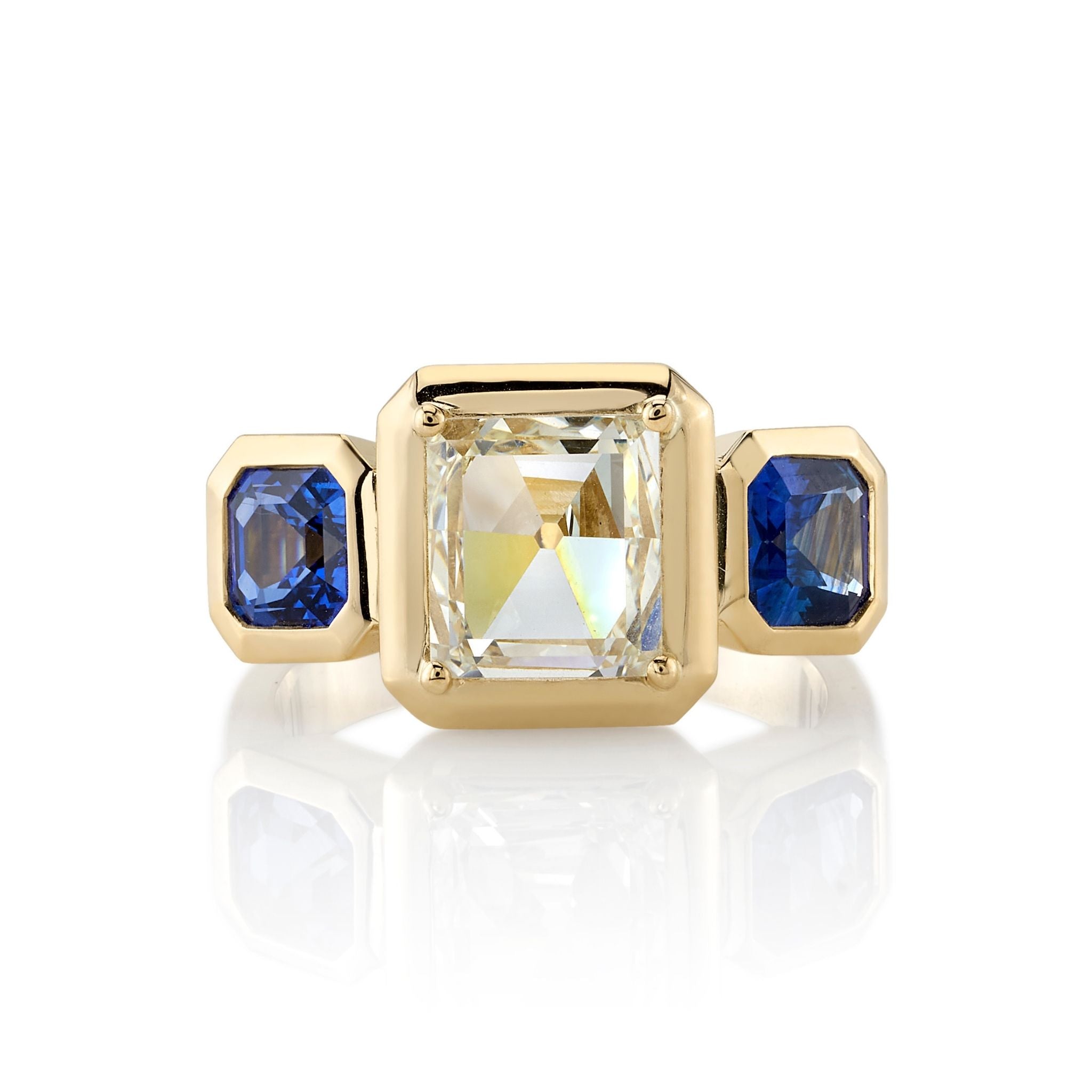 SINGLE STONE GLORIA RING featuring 1.77ct K/VS1 GIA certified rectangular mixed cut diamond with 1.65ctw blue sapphire accent stones set in a handcrafted 18K yellow gold mounting.