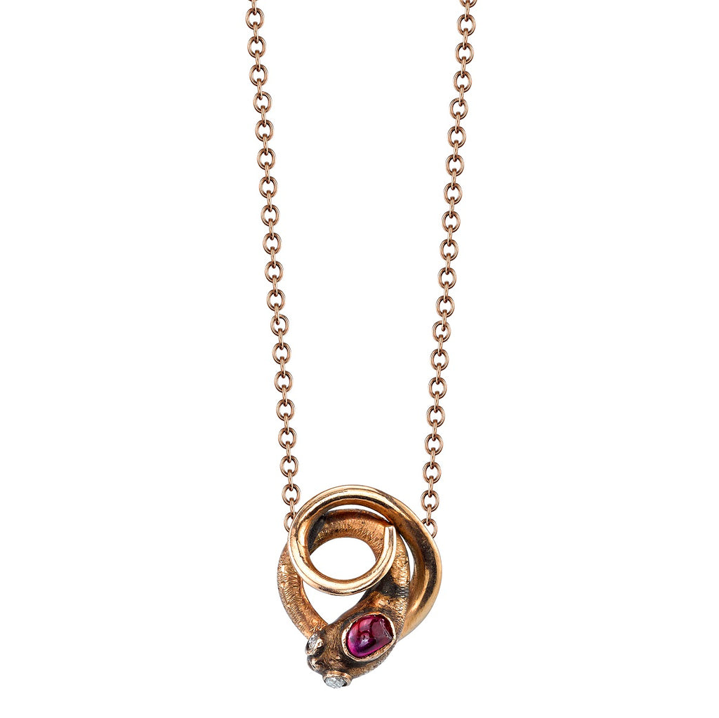 
Single Stone's Benson earrings  featuring 0.06ct rose cut ruby set in a vintage Victorian era 18K rose gold snake pendant on an 18K rose gold link chain.
