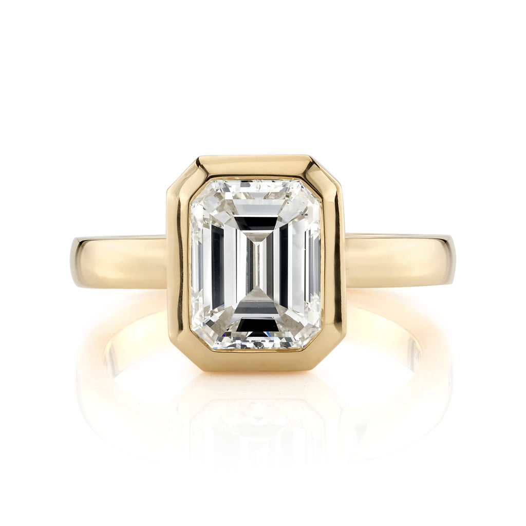 
Single Stone's Rae ring  featuring 2.28ct O-P/VS1 GIA certified emerald cut diamond bezel set in a handcrafted 18K yellow gold mounting.
 
