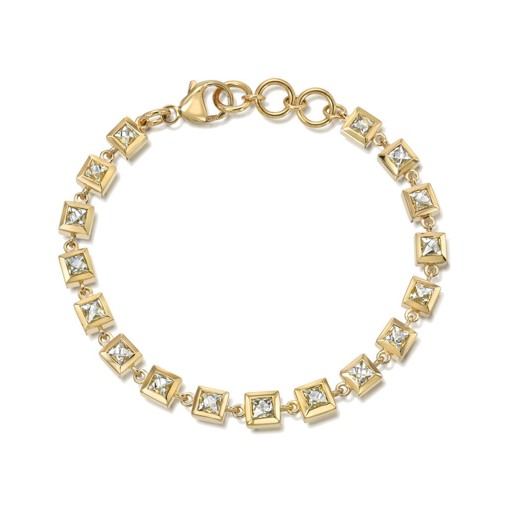 
Single Stone's Small karina bracelet ring  featuring 6.45ctw F-G/VS-SI French cut diamonds bezel set on a handcrafted 18K yellow gold tennis bracelet.
Bracelet measures 7.25".
