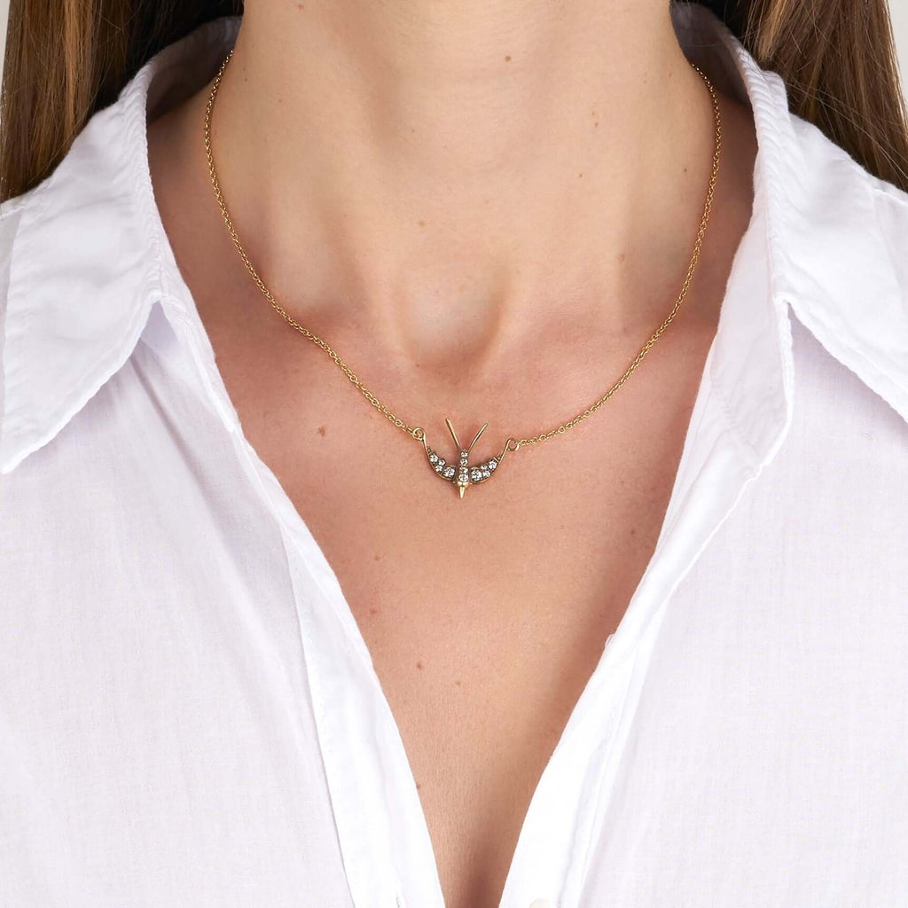 Single Stone's SMALL SWALLOW PENDANT NECKLACE  featuring Approximately 0.30ctw G-H/VS old European cut diamonds set in a handcrafted 18K yellow and champagne gold Swallow pendant. Necklace measures 16&quot;.
