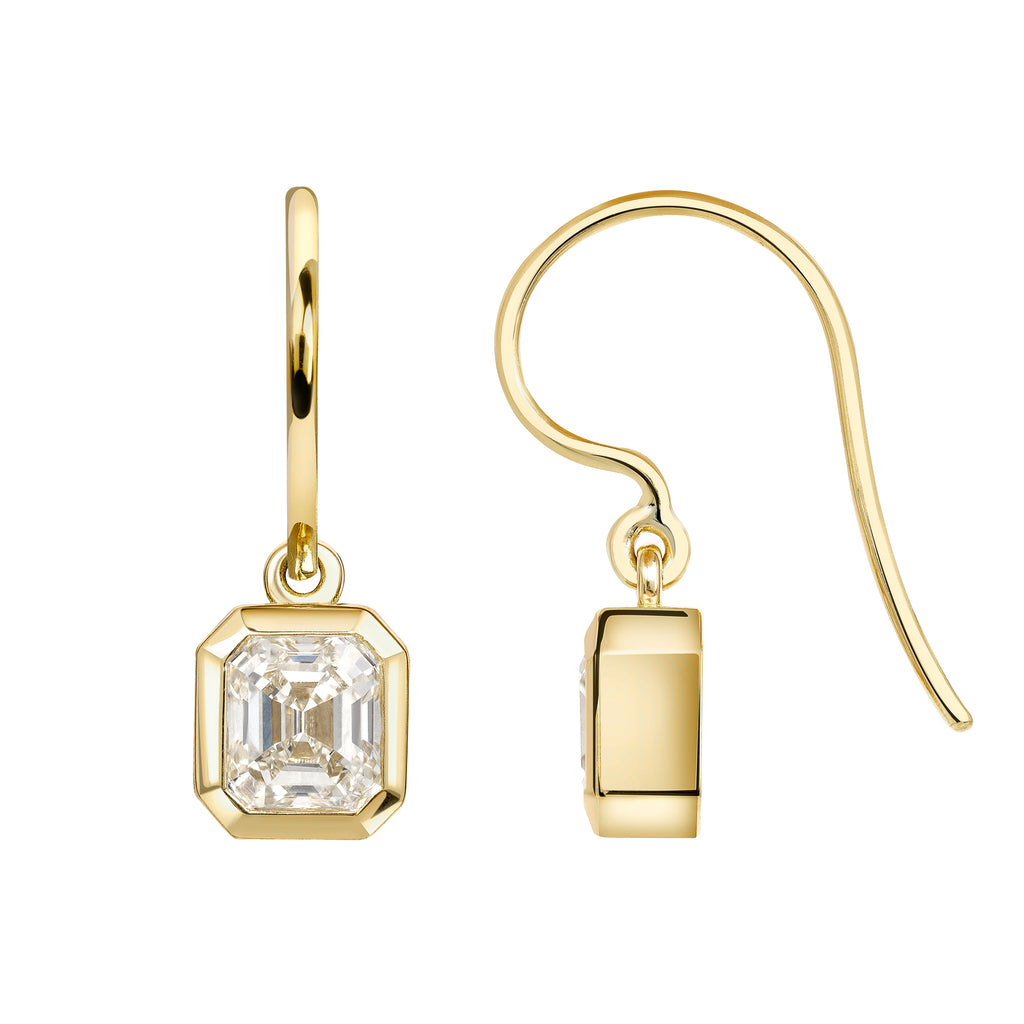 
Single Stone's Teddi drops earrings  featuring 2.13ctw L/VS1-VS2 GIA certified Asscher cut diamonds bezel set in handcrafted 18K yellow gold drop earrings.
