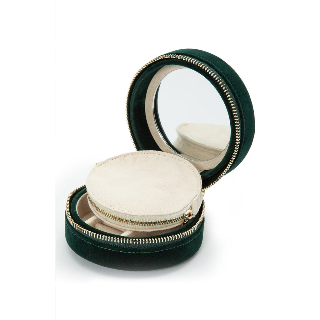 Single Stone's ZOE ROUND TRAVEL CASE  featuring Forest green velvet Mirror, 7 ring rolls, 2 compartments and a zip pouch LusterLoc™: Allows the fabric lining the inside of your jewelry cases to absorb the hostile gases known to cause tarnishing. Under typical storage conditions, it can prevent tarnishing for up to 35 years.
