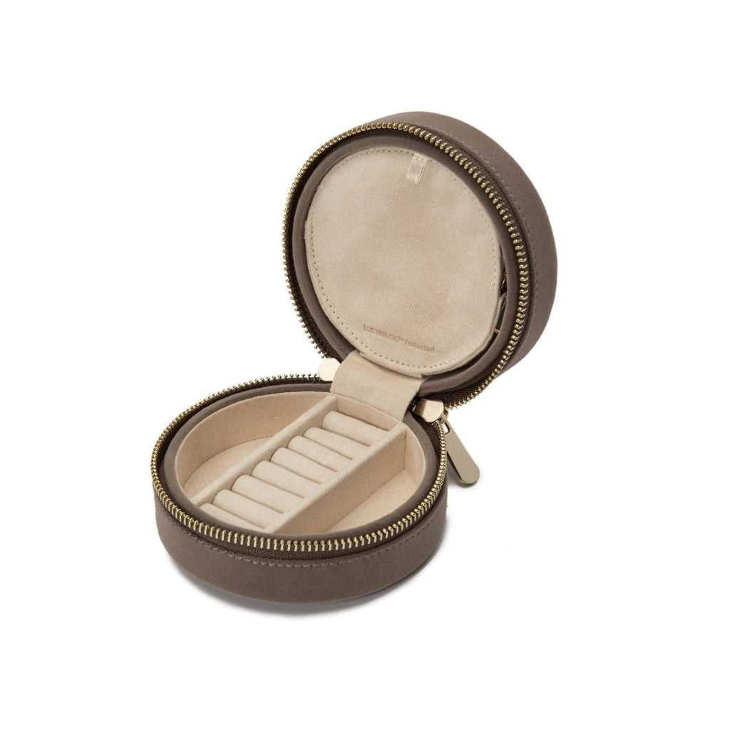 Single Stone's ZOE ROUND TRAVEL CASE  featuring Mink velvet Mirror, 7 ring rolls, 2 compartments and a zip pouch LusterLoc™: Allows the fabric lining the inside of your jewelry cases to absorb the hostile gases known to cause tarnishing. Under typical storage conditions, it can prevent tarnishing for up to 35 years.
